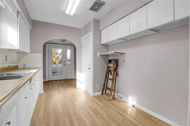 a view of a storage & utility room with closet wooden floor