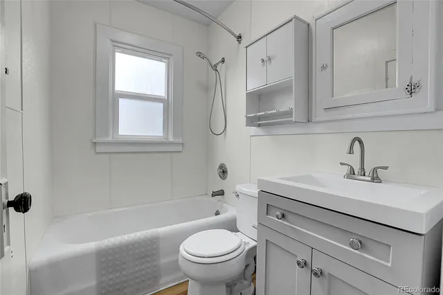 a bathroom with a sink a toilet and a bathtub