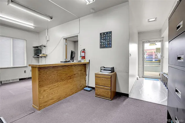 a view of kitchen with refrigerator and window