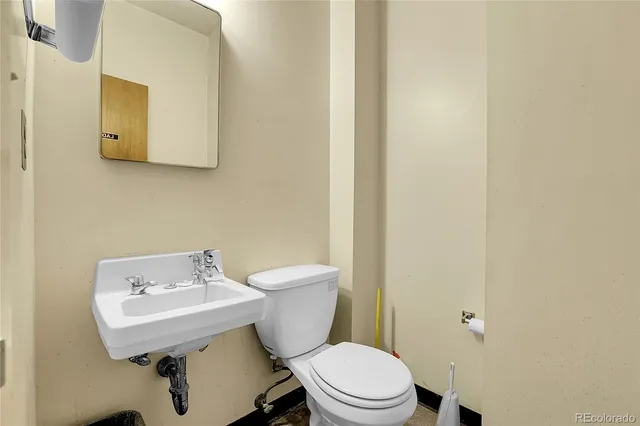 a white toilet sitting next to a bathroom sink