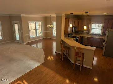 en empty room with windows and fireplace