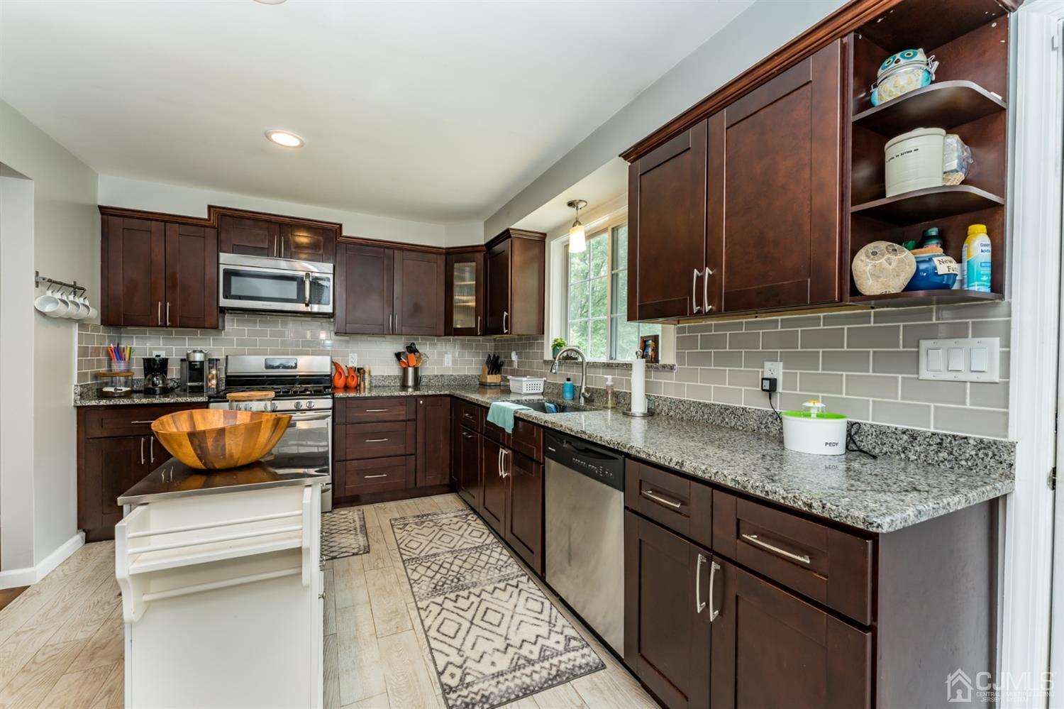 1077 Cranbrook Road Union, NJ 07083 - Photo 12 of 37 a kitchen with granite countertop a sink stove and cabinets