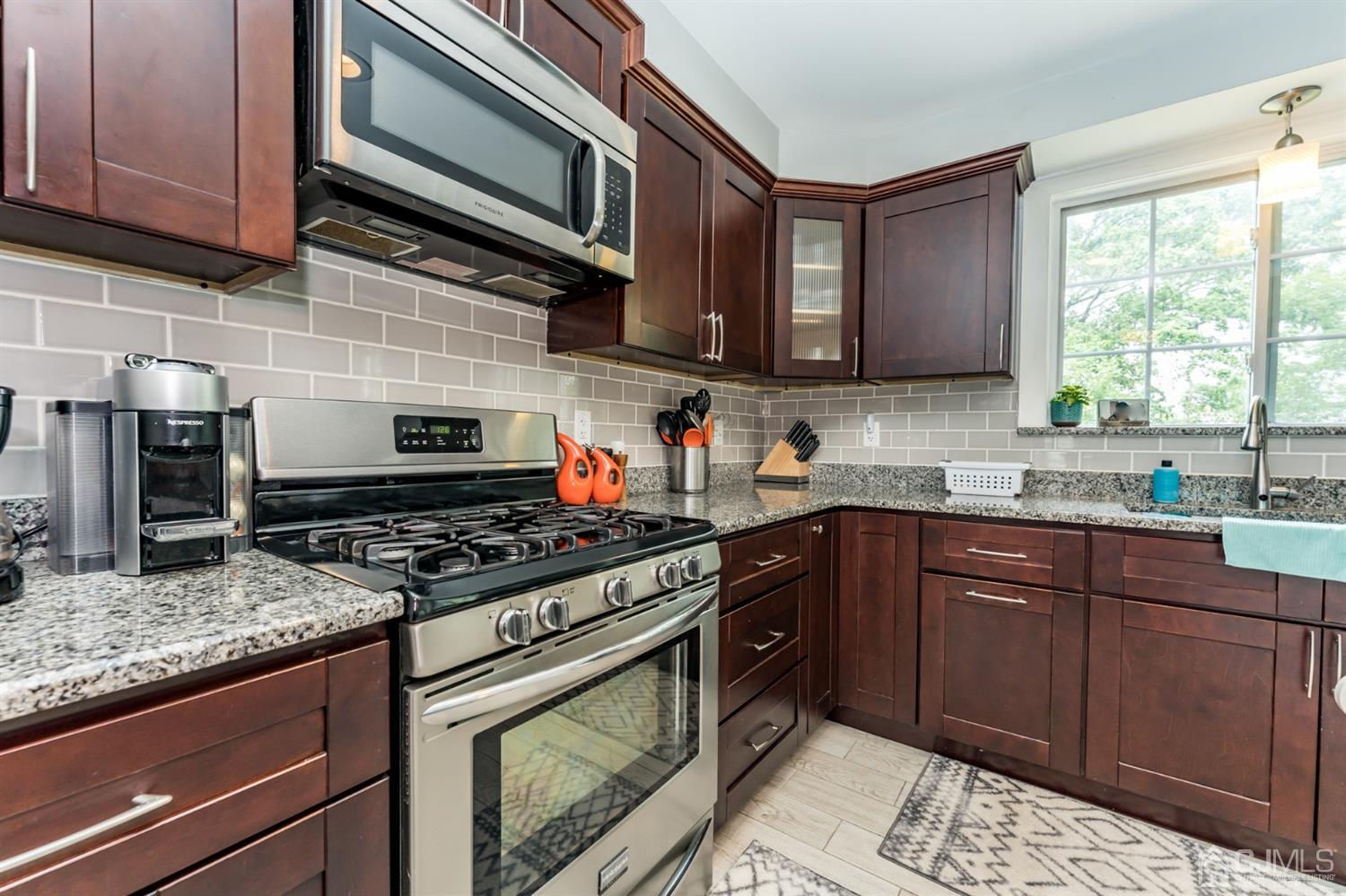 1077 Cranbrook Road Union, NJ 07083 - Photo 16 of 37 a kitchen with stainless steel appliances granite countertop a stove sink and cabinets