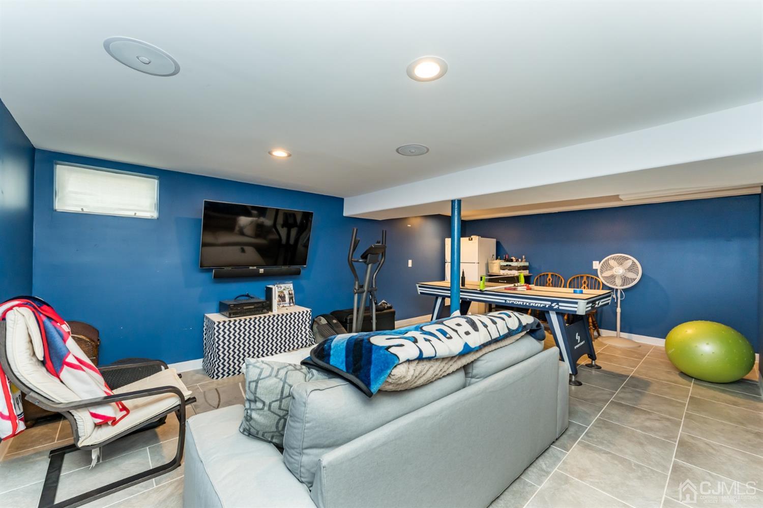 1077 Cranbrook Road Union, NJ 07083 - Photo 23 of 37 a living room with furniture and a flat screen tv