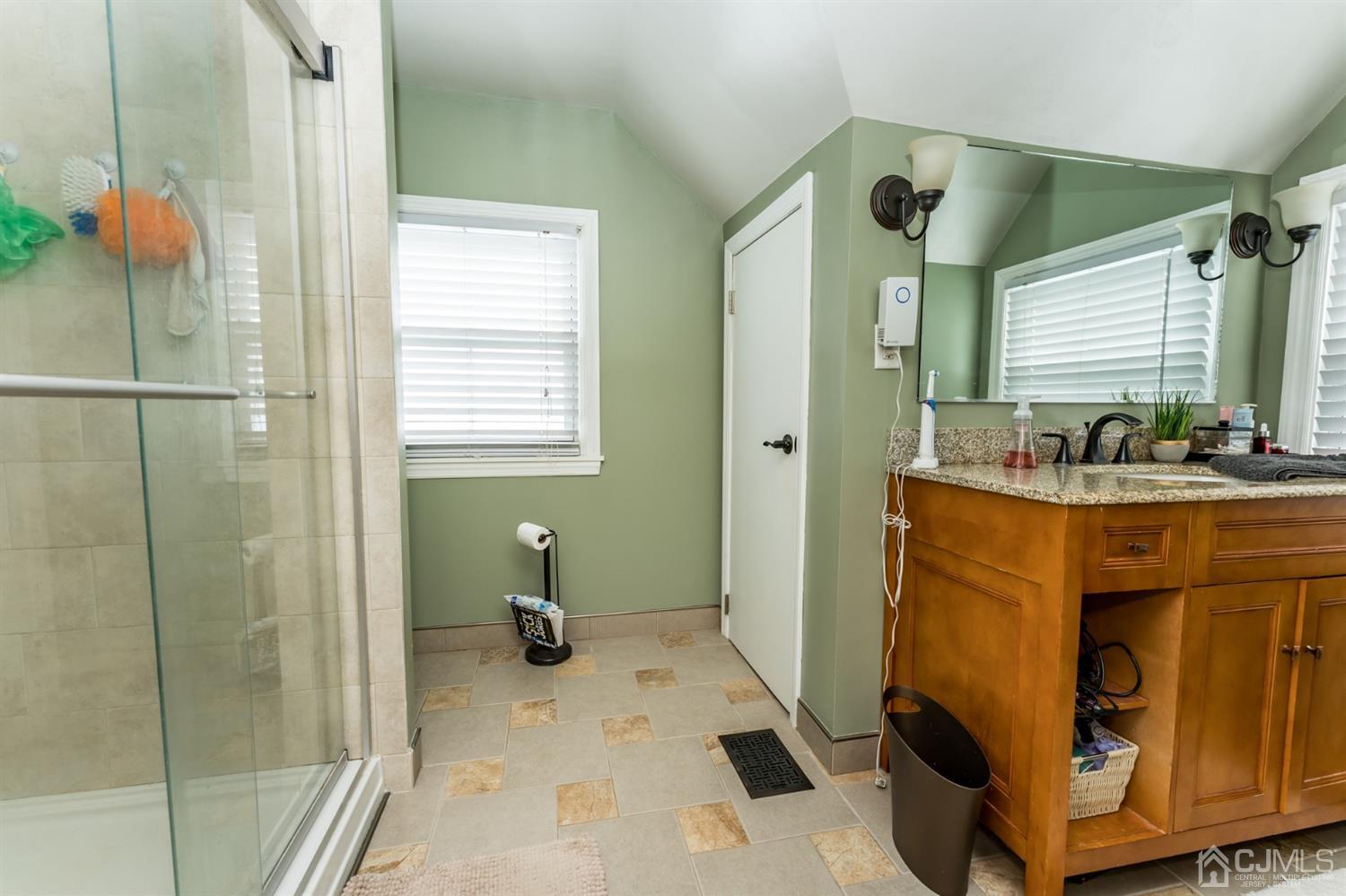1077 Cranbrook Road Union, NJ 07083 - Photo 27 of 37 a bathroom with a sink mirror and shower