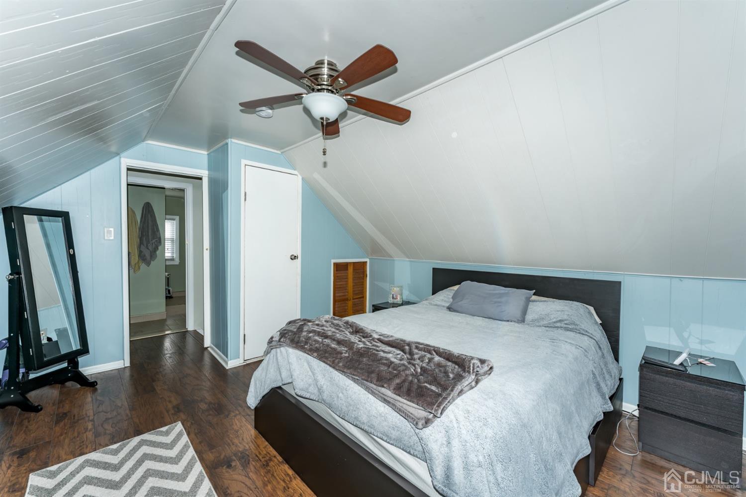 1077 Cranbrook Road Union, NJ 07083 - Photo 30 of 37 a bedroom with a bed a chandelier and a flat screen tv