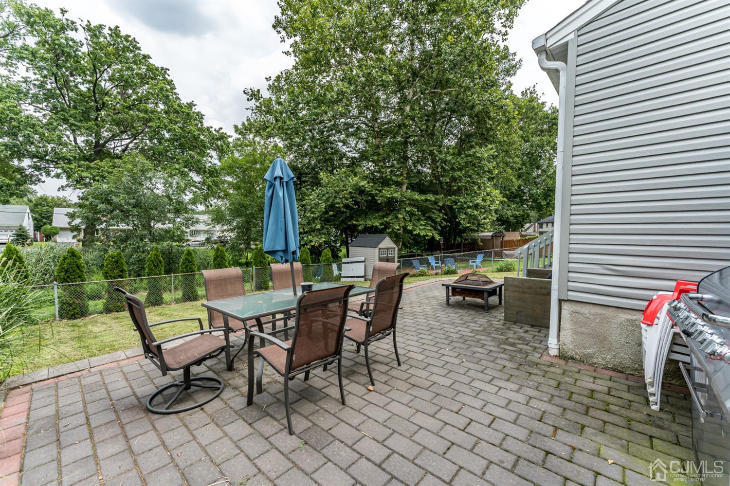 1077 Cranbrook Road Union, NJ 07083 - Photo 32 of 37 a view of a patio with a dining table and chairs with wooden fence