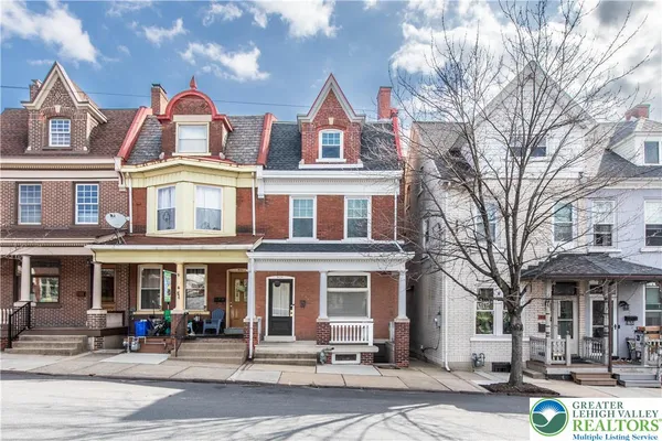 a front view of a residential apartment building with a yard