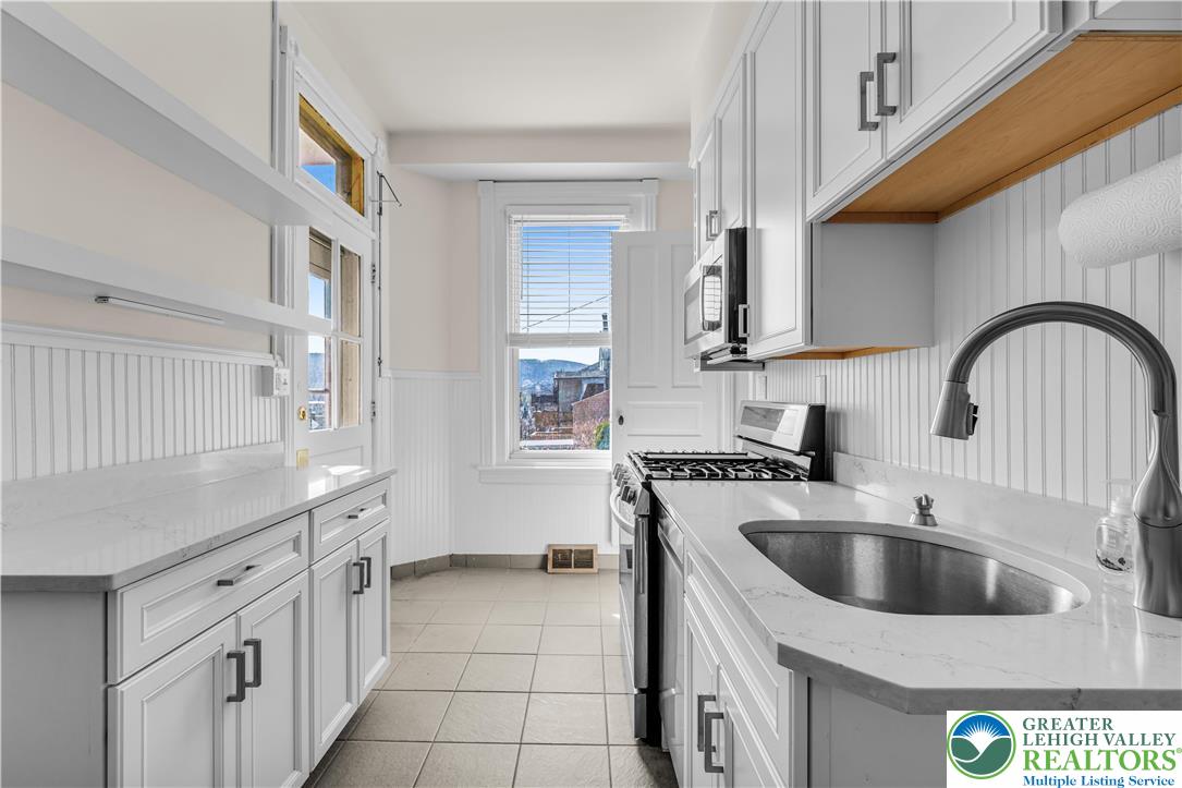 420 2nd Avenue Bethlehem, PA 18018 - Photo 8 of 34 a kitchen with a sink a stove and cabinets