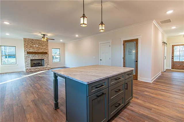 a kitchen with stainless steel appliances granite countertop a sink a stove and a refrigerator