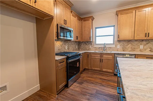 a kitchen with a stove and a sink