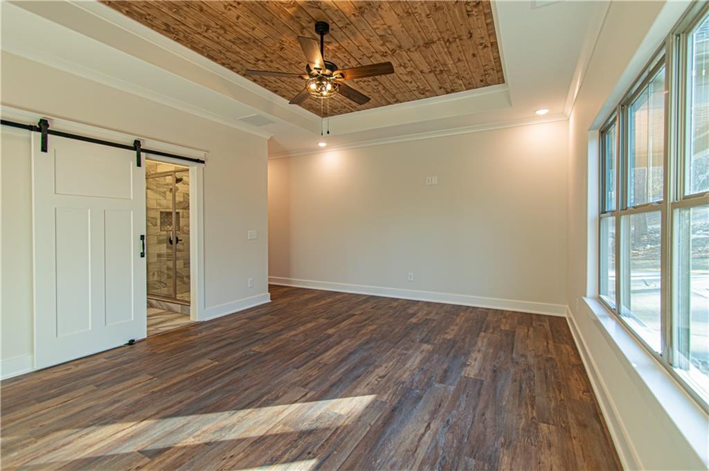 386 Mulberry Circle Jasper, GA 30143 - Photo 25 of 46 a view of empty room with wooden floor and fan