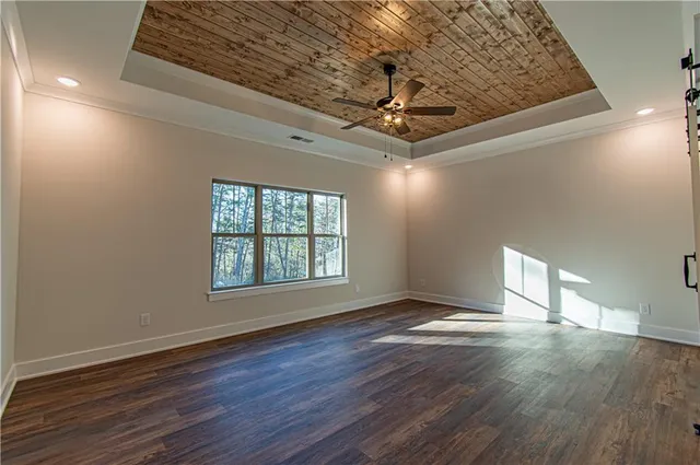 a view of an empty room and wooden floor