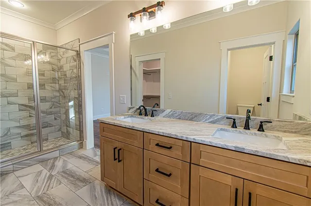 a bathroom with a glass shower door