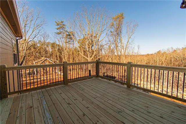 a view of a balcony with wooden floor and fence