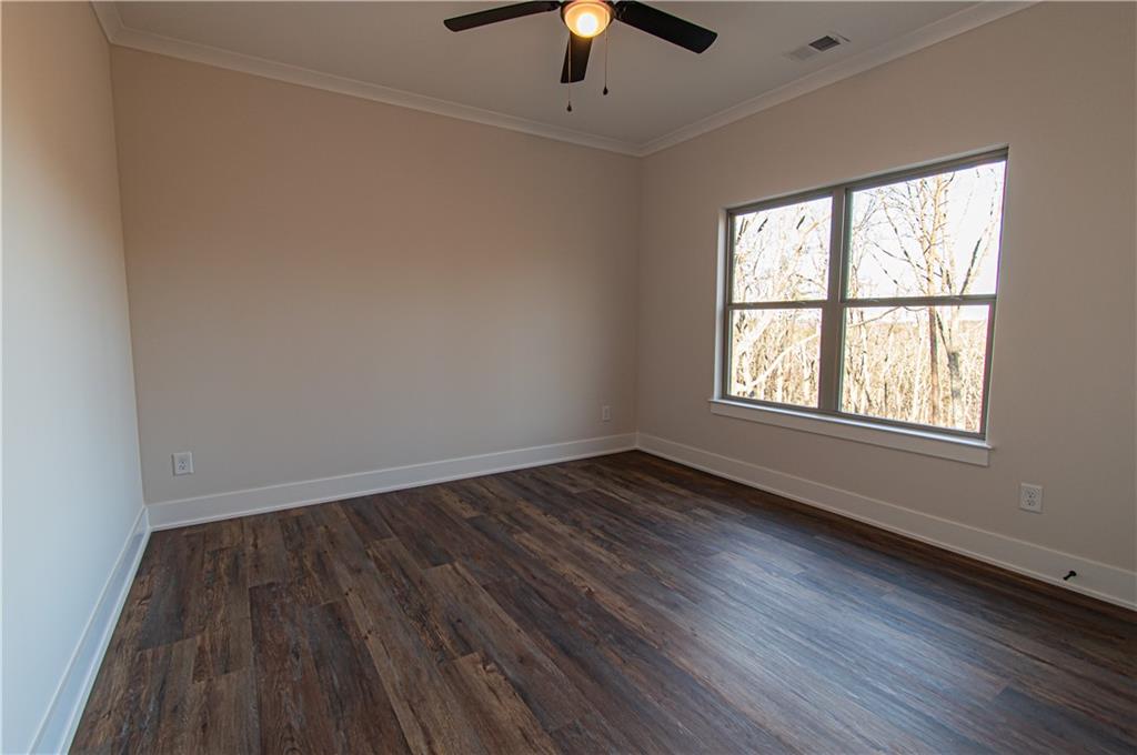 386 Mulberry Circle Jasper, GA 30143 - Photo 32 of 46 an empty room with wooden floor chandelier fan and windows