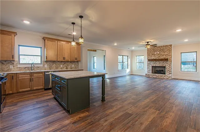 a kitchen with a refrigerator and a stove top oven