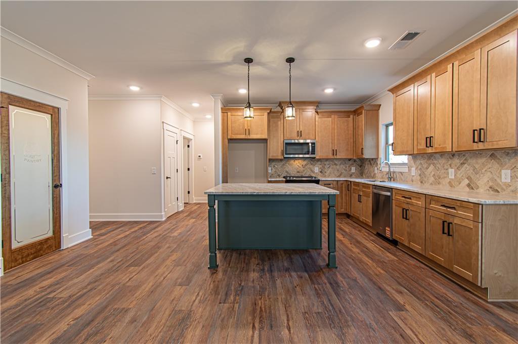 386 Mulberry Circle Jasper, GA 30143 - Photo 10 of 46 a kitchen with kitchen island a sink stainless steel appliances and cabinets