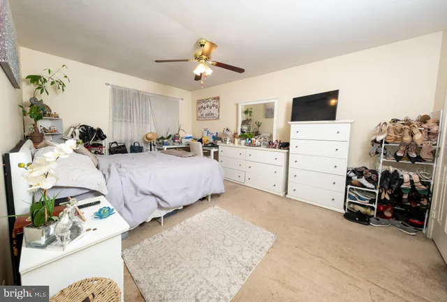 a bedroom with furniture and a flat screen tv