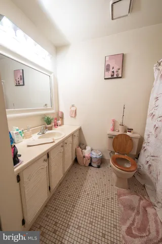 a bathroom with a sink mirror and toilet