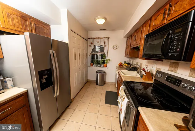 a kitchen with stainless steel appliances a stove a refrigerator and a sink