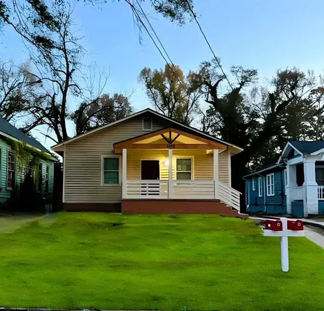 a front view of house with a garden