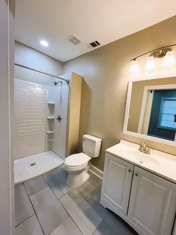 a bathroom with a sink toilet and shower