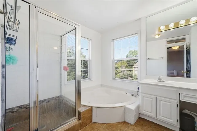 a bedroom with a bed and a ceiling fan