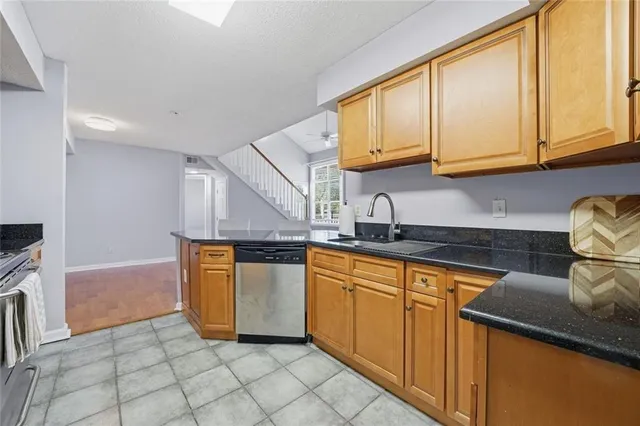 a kitchen with stainless steel appliances granite countertop a stove and a microwave