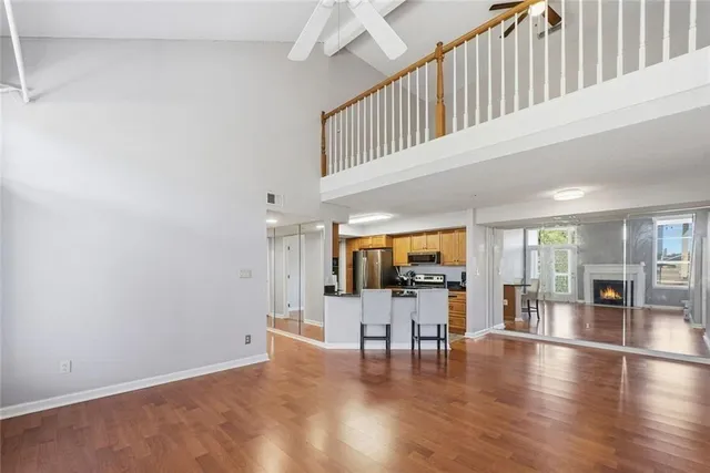 a bedroom with a large bed and a flat tv screen on dresser