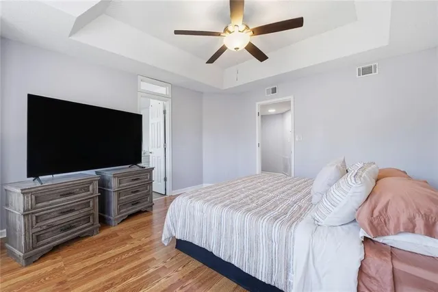 a bedroom with a bed and a ceiling fan