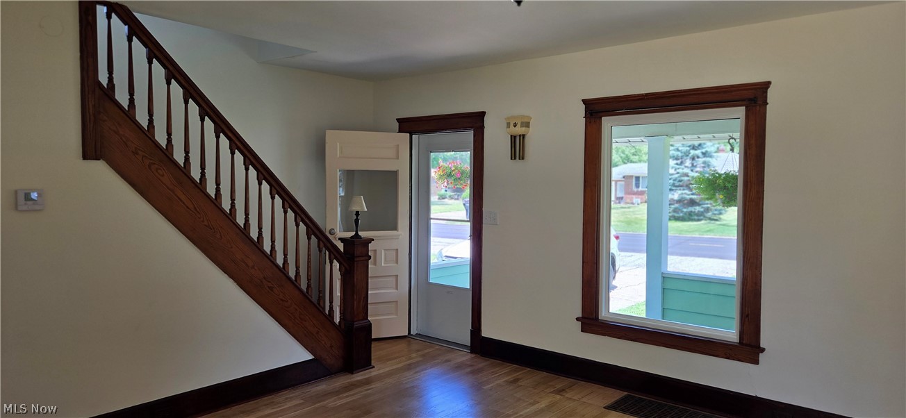 9964 East River Road Elyria, OH 44035 - Photo 7 of 45 Hardwood flooring throughout featuring a wood staircase with balusters and newel post