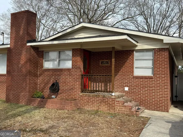 a front view of a house with brick walls