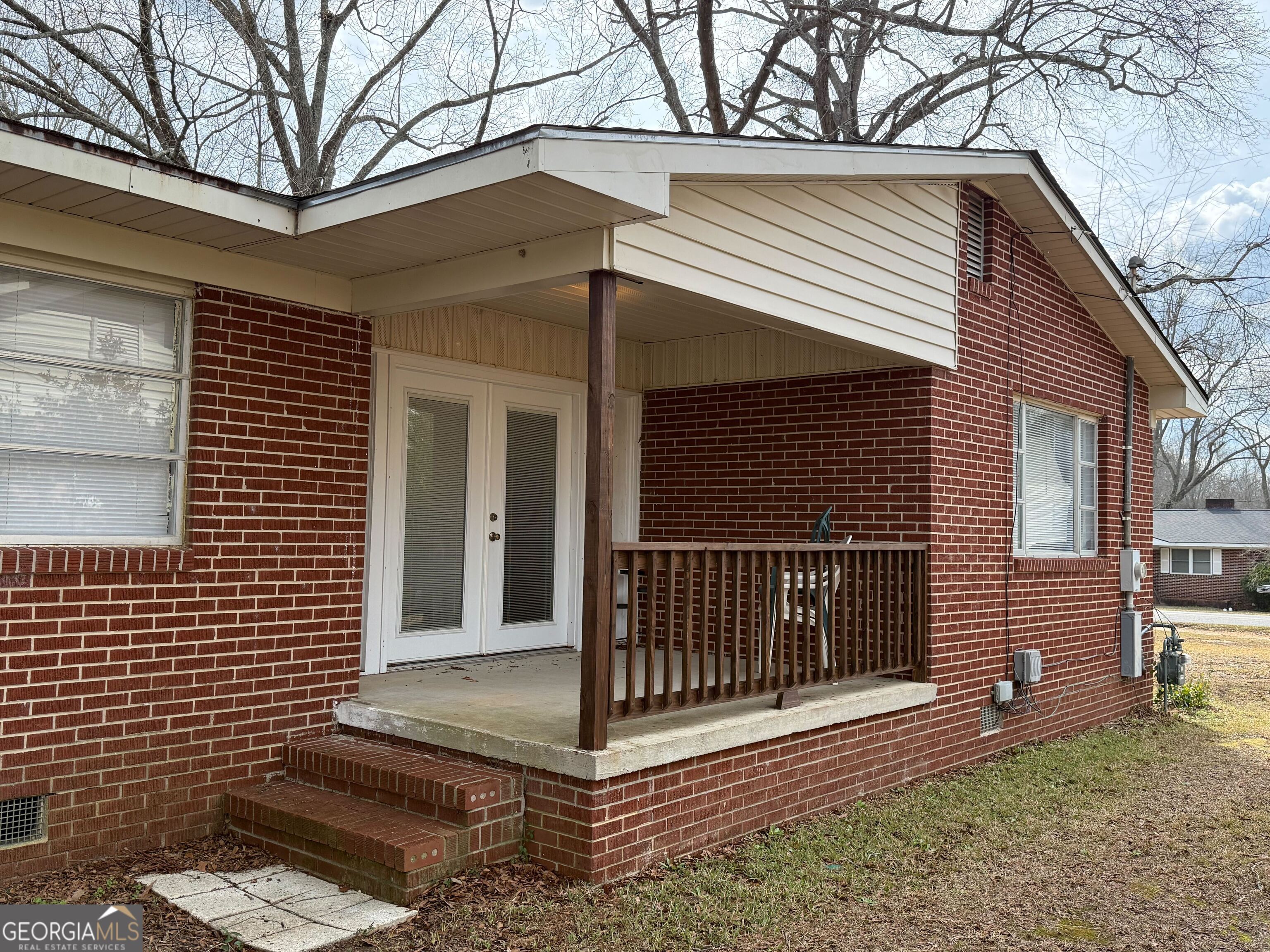 804 Betty Street Sandersville, GA 31082 - Photo 4 of 21 a view of a house with a small yard and wooden fence