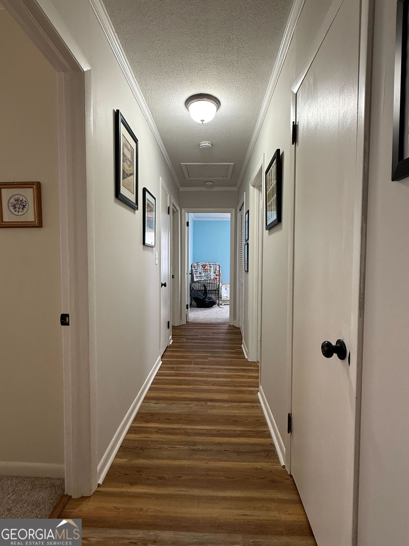 804 Betty Street Sandersville, GA 31082 - Photo 6 of 21 a view of a hallway with wooden floor and staircase