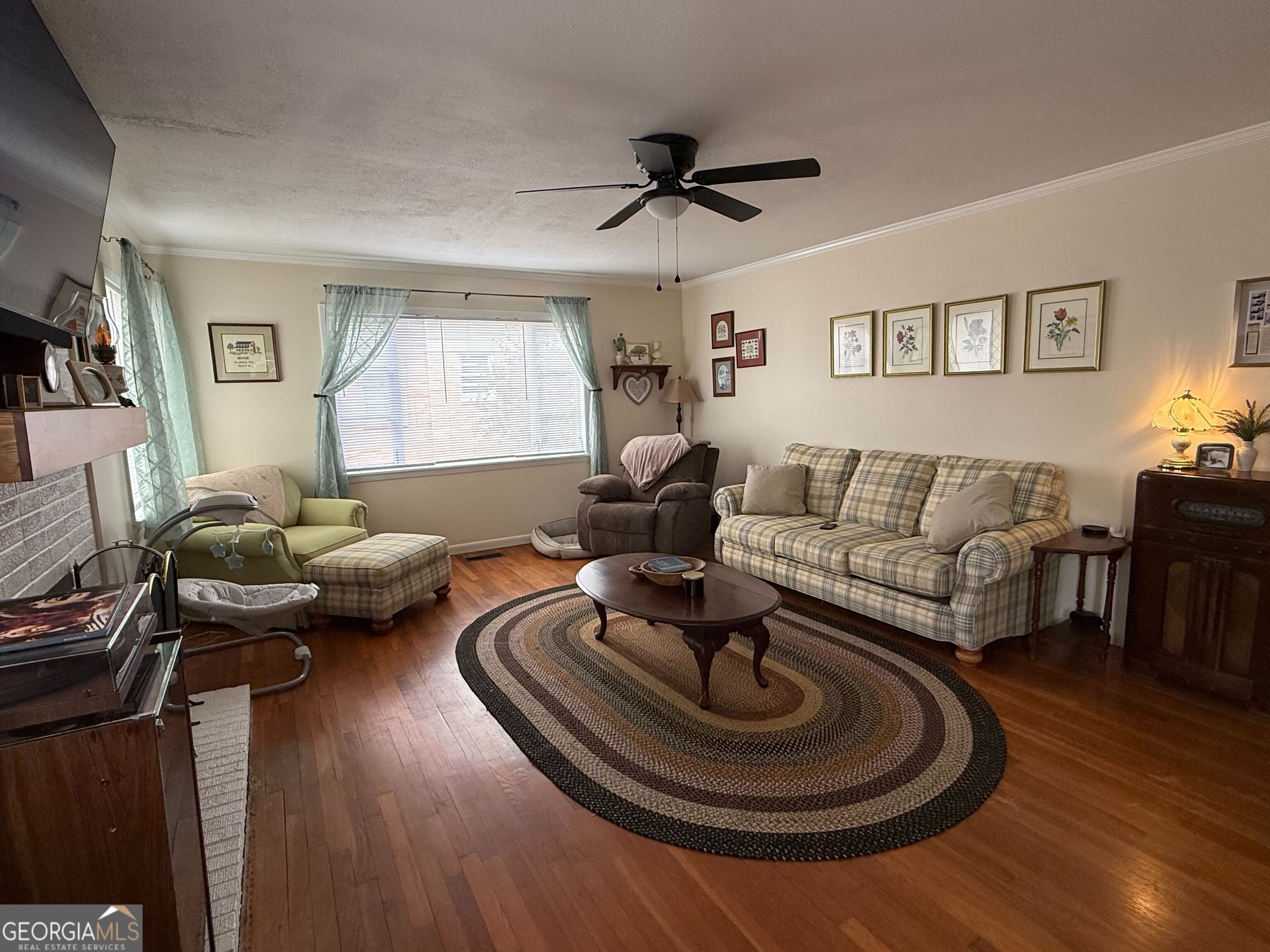 804 Betty Street Sandersville, GA 31082 - Photo 7 of 21 a living room with furniture and a wooden floor