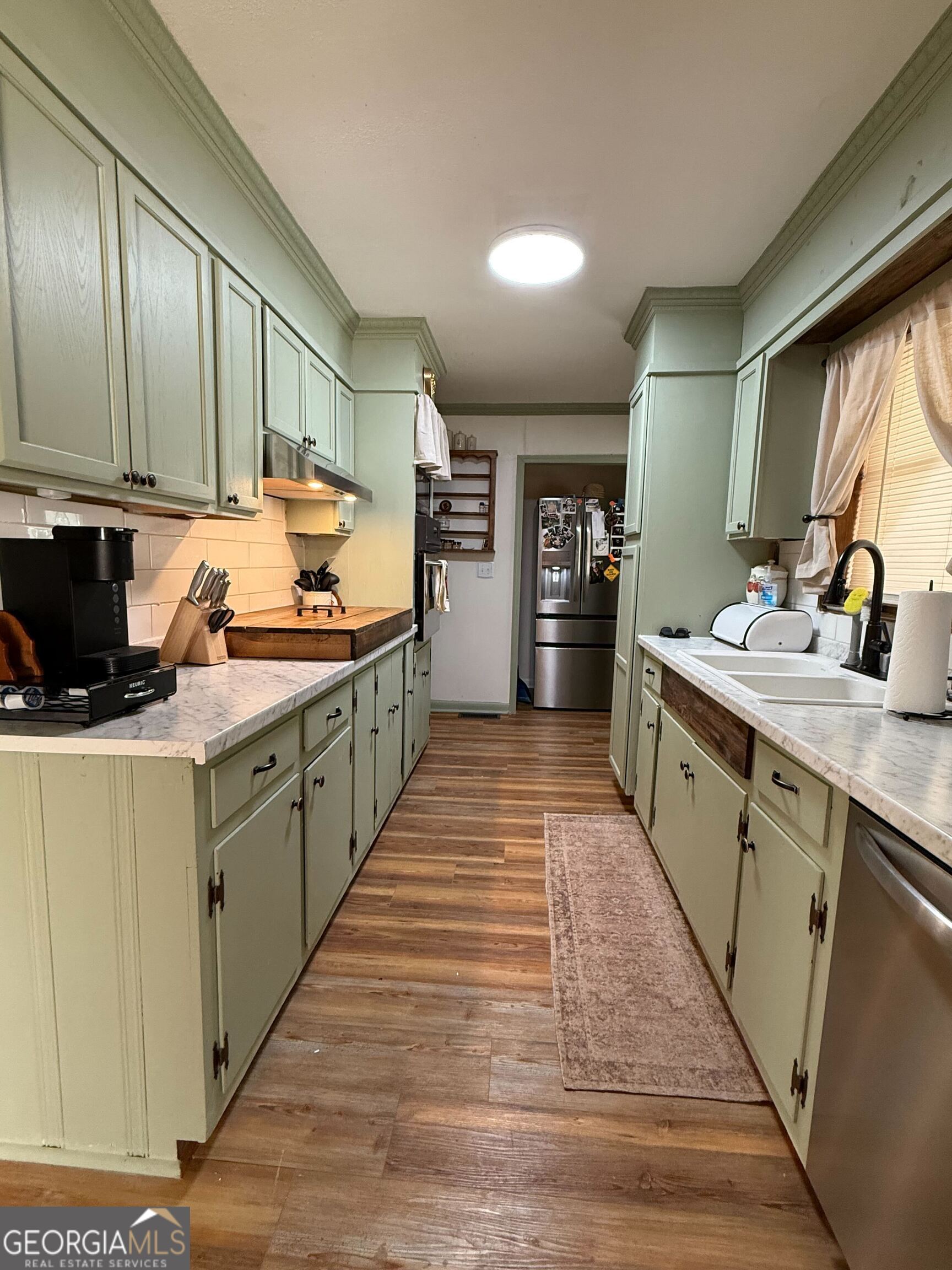804 Betty Street Sandersville, GA 31082 - Photo 9 of 21 a kitchen with stainless steel appliances a sink and cabinets