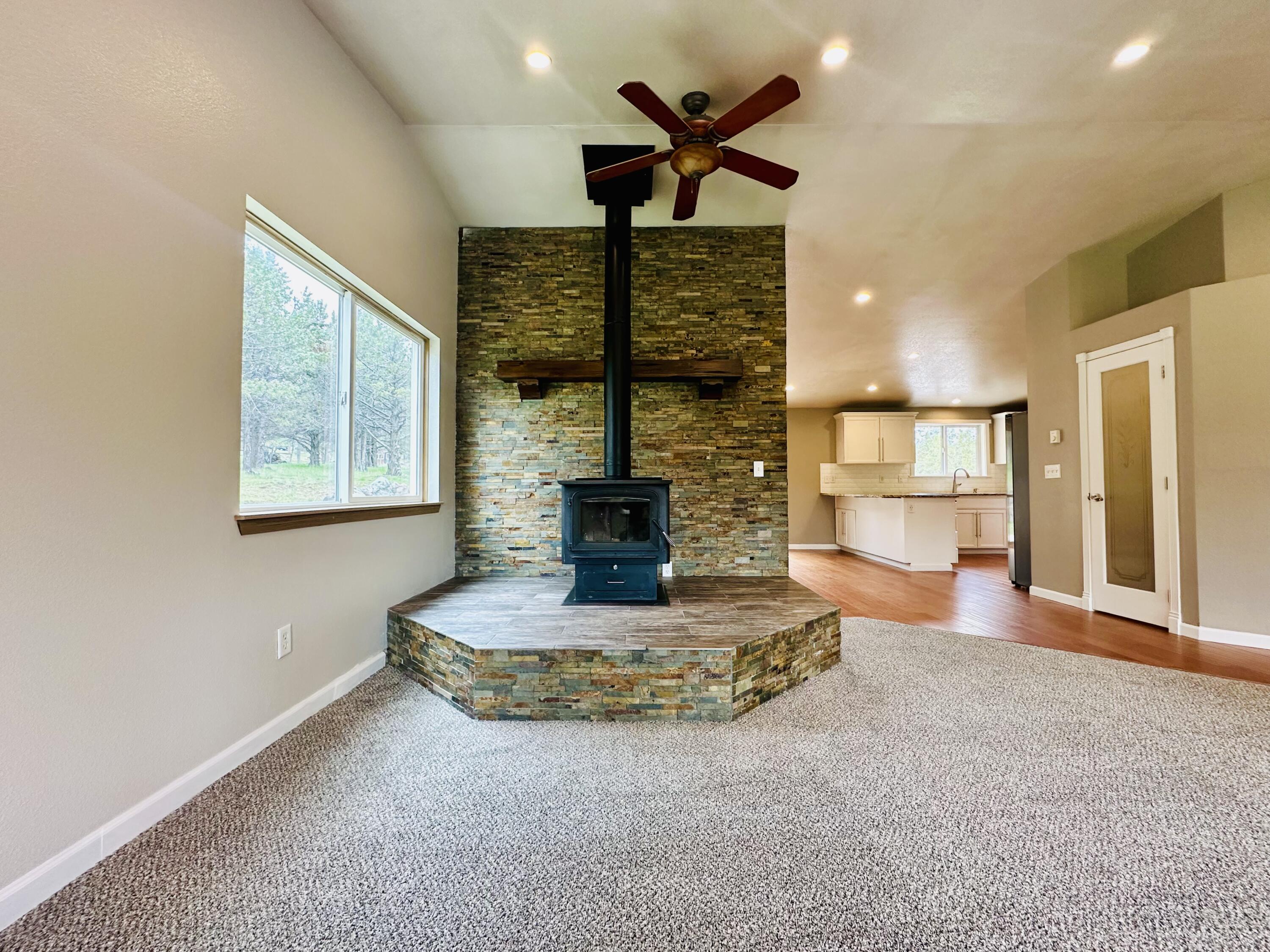 16524 Fieldcrest Road Klamath Falls, OR 97603 - Photo 11 of 58 a living room with fireplace furniture and a chandelier