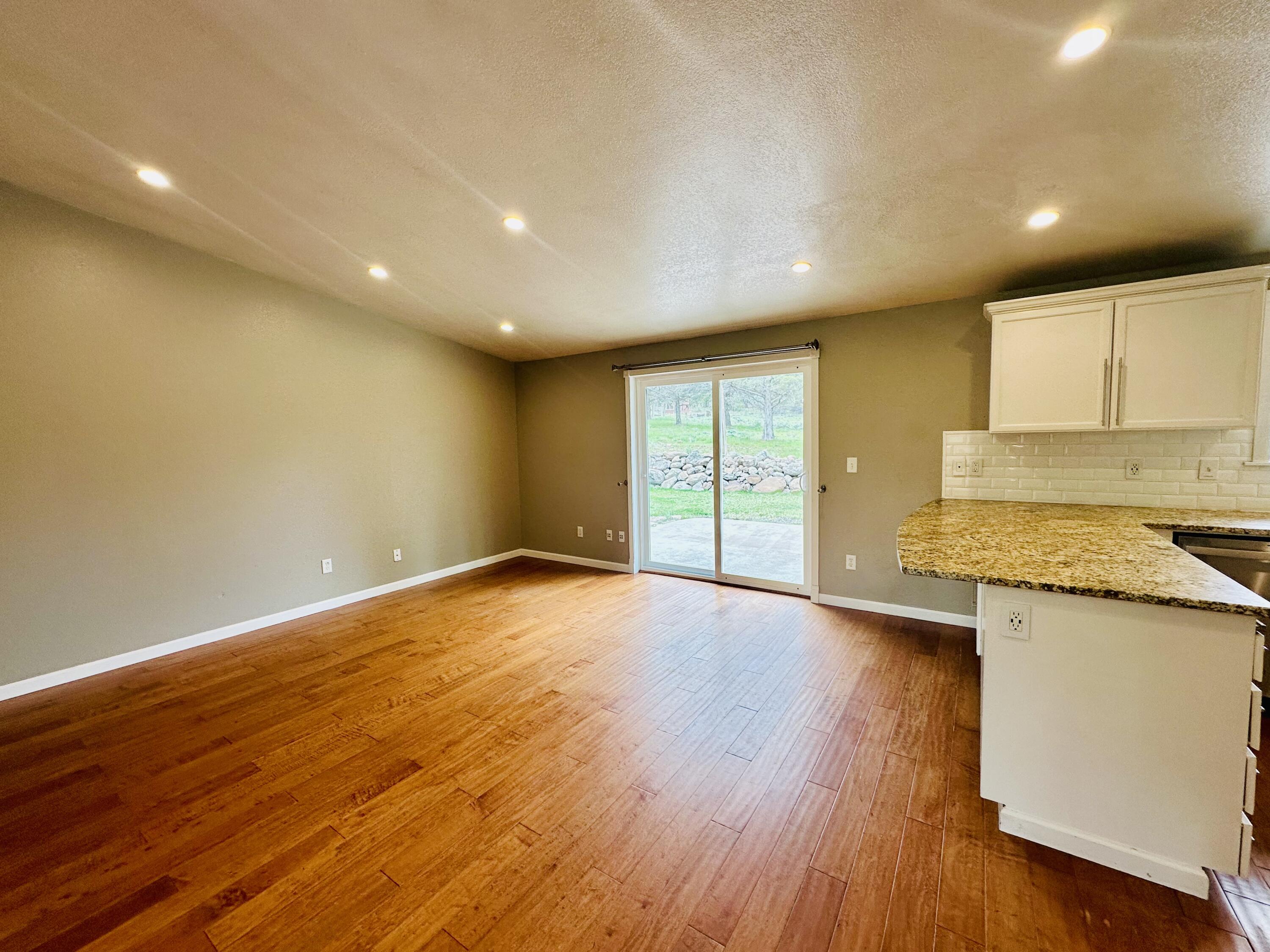 16524 Fieldcrest Road Klamath Falls, OR 97603 - Photo 14 of 58 a view of an empty room with wooden floor and a window