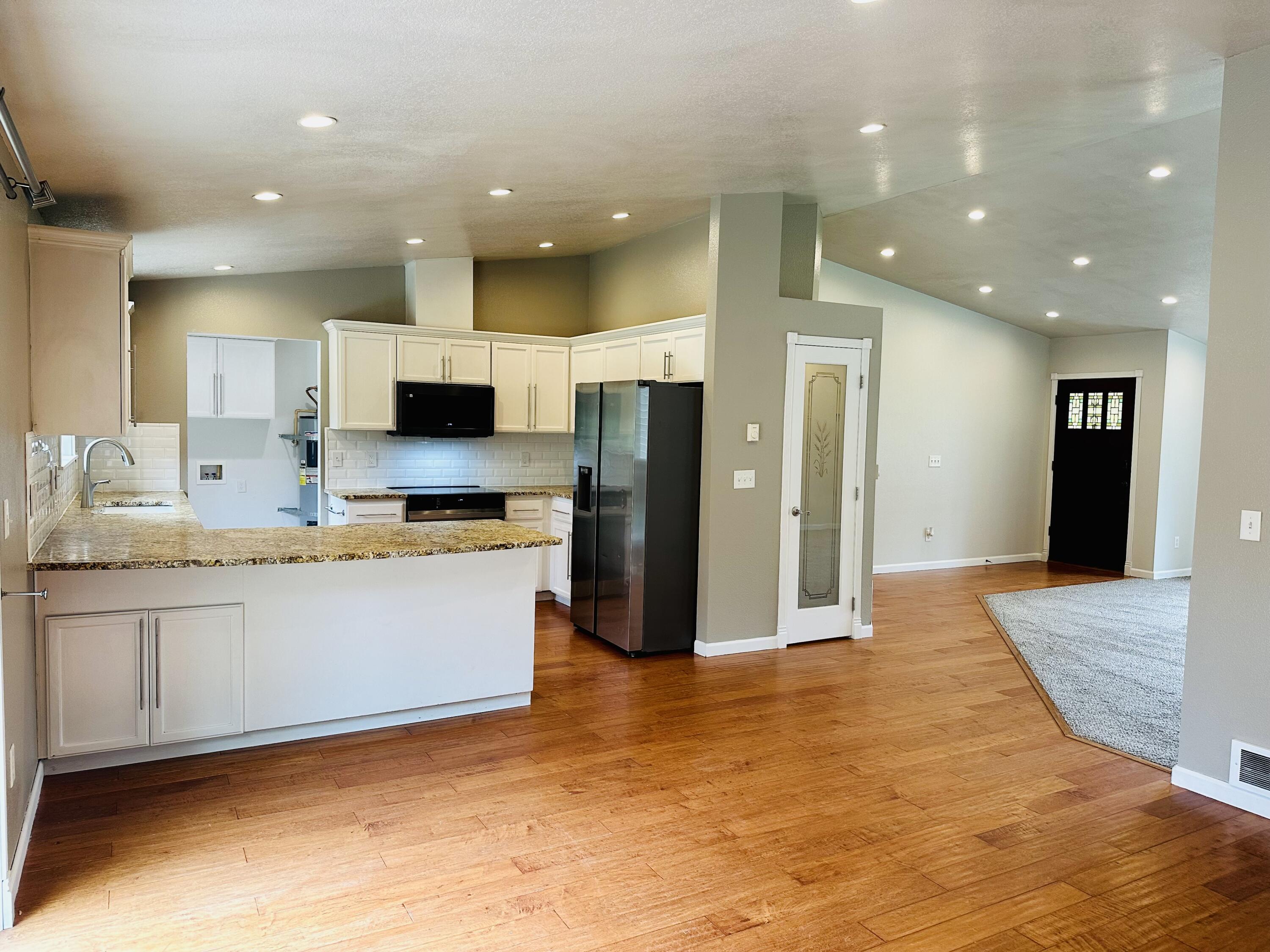 16524 Fieldcrest Road Klamath Falls, OR 97603 - Photo 15 of 58 a large kitchen with stainless steel appliances kitchen island granite countertop a refrigerator and a sink