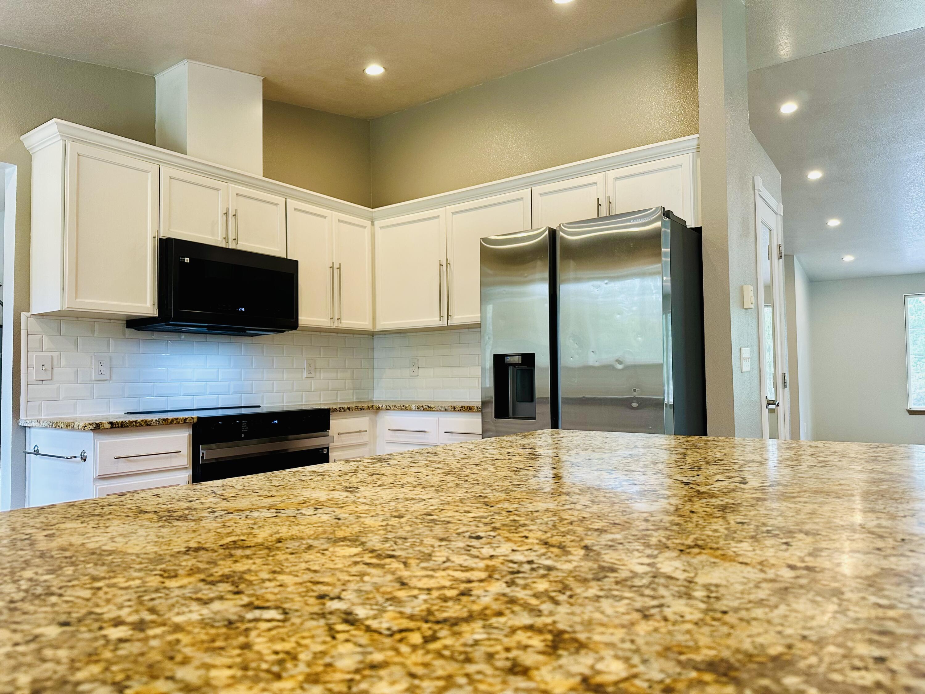 16524 Fieldcrest Road Klamath Falls, OR 97603 - Photo 16 of 58 a kitchen with granite countertop a refrigerator and a sink