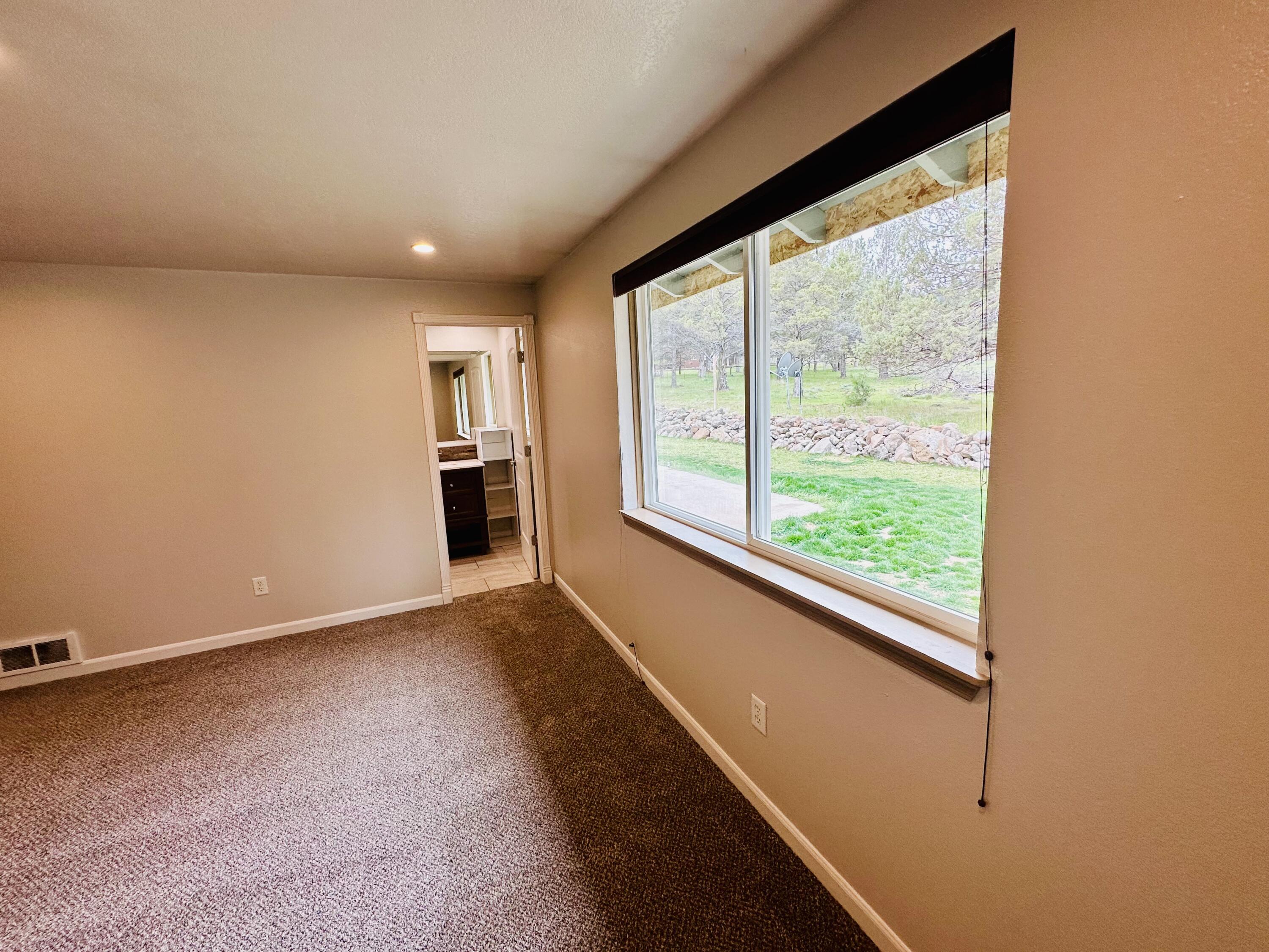 16524 Fieldcrest Road Klamath Falls, OR 97603 - Photo 31 of 58 a view of an empty room with wooden floor and a window