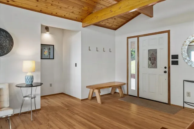 a view of a room with wooden floor cabinet and windows