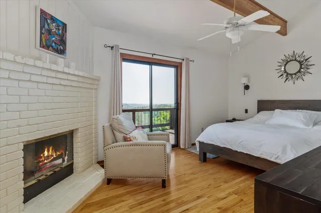 a bedroom with a bed and a fireplace