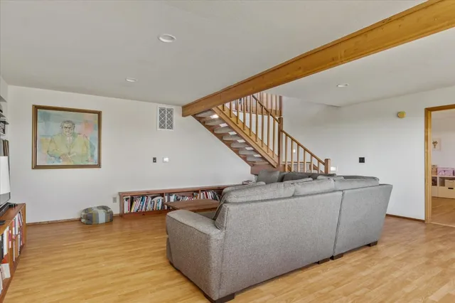 a living room with furniture and stairs