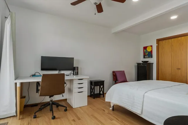 a bedroom with a workspace