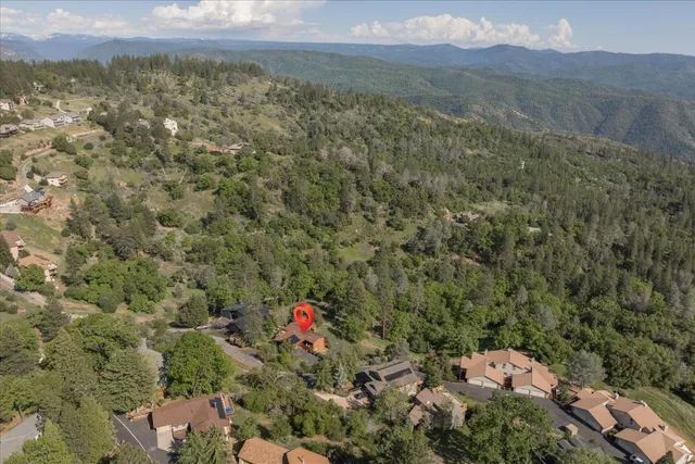 a view of a field with mountains in the background
