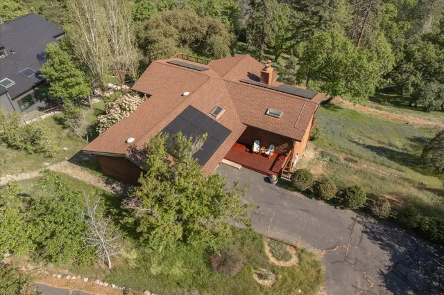 an aerial view of a house with a yard