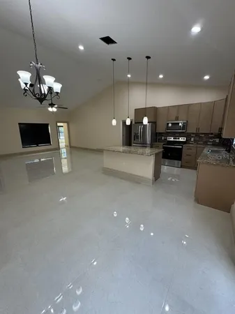 a kitchen with a sink a counter top space appliances and cabinets