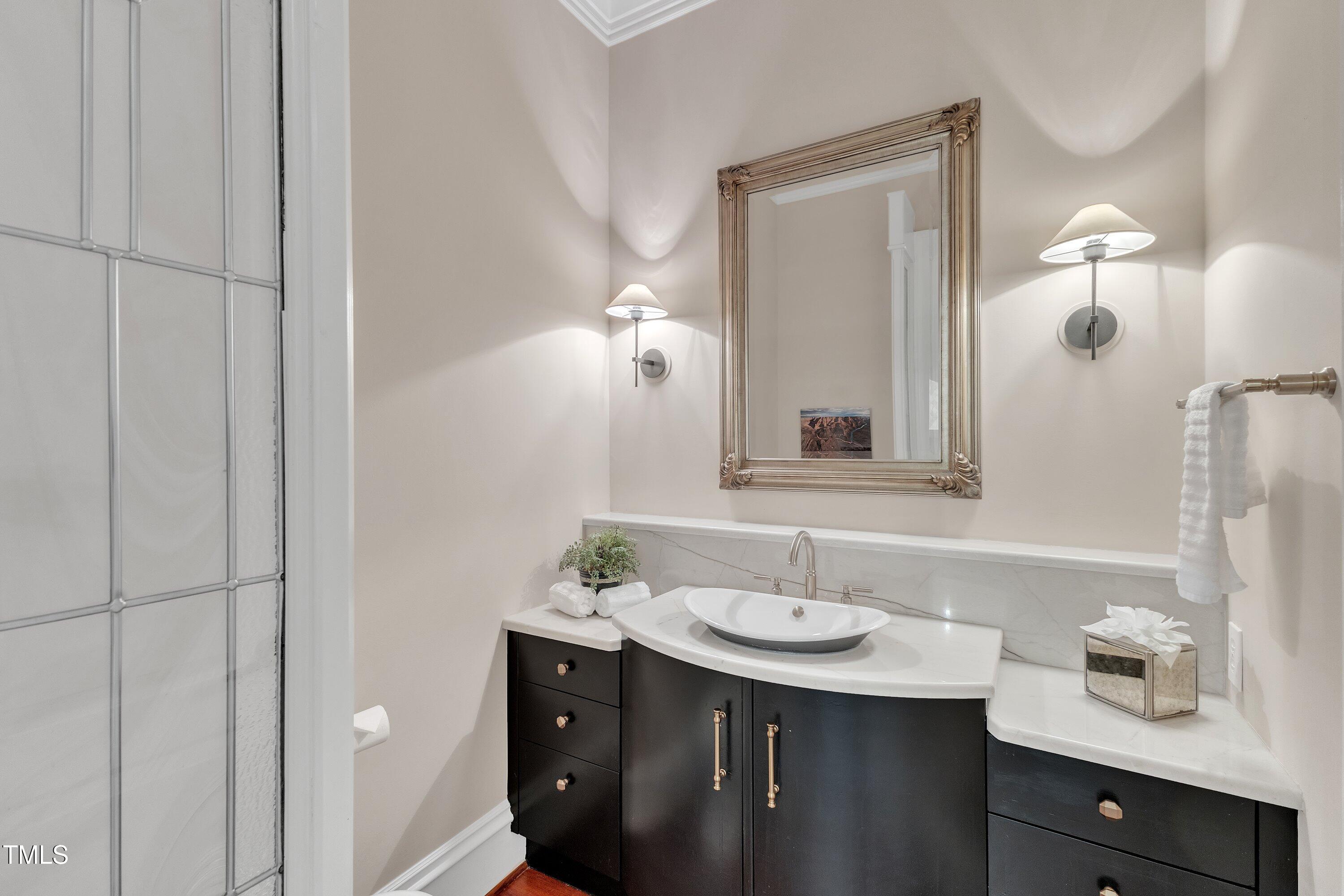 2117 Buckingham Road Raleigh, NC 27607 - Photo 20 of 82 a bathroom with a sink and a mirror